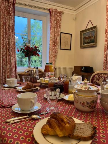 a table with a table cloth with croissants on it at Manoir du Val Fouzon - Beauval in La Vernelle