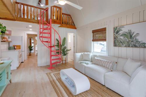 a living room with a white couch and a red staircase at Hope Home in Clermont