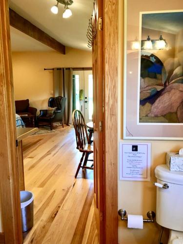 a room with a toilet and a living room at Heartstone Country Retreat in Buena Vista