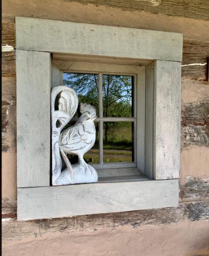 a window with a bird statue on the side of a building at Heartstone Country Retreat in Buena Vista