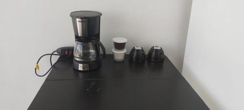 a black counter with a blender and some shoes at Riverfront Retreat Prime Location Apartment with Stunning Views of the RioNegro in Manaus