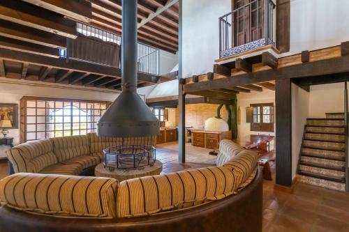 a living room with a couch and a fireplace at La Kasona del mirador in Córdoba