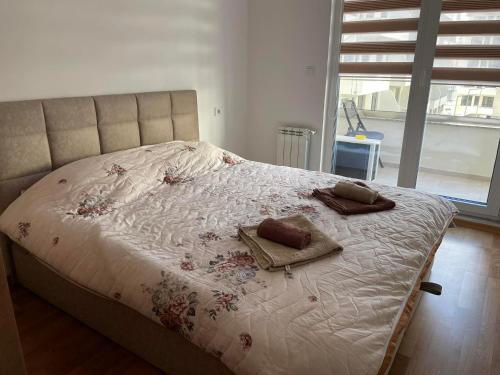 a bedroom with a bed with two pillows on it at Golden Apartments Skopje in Skopje