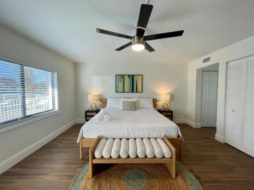 a bedroom with a bed and a ceiling fan at Melbourne Beach Resort in Melbourne Beach