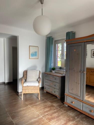a living room with a chair and a dresser at Casa Anna in Villach
