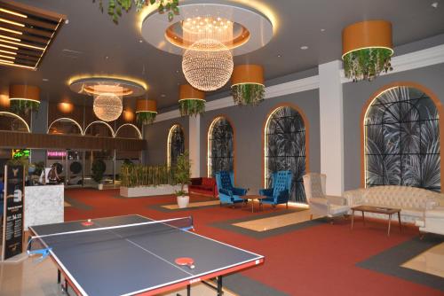 a lobby with a ping pong table and chairs at TEVETOGLU HOTEL in Istanbul