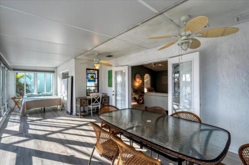a dining room with a table and chairs at 15826 Aqua in Placida