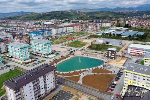 an aerial view of a city with a pool at Apartman Andrea in Lukavica