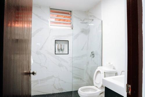 a bathroom with a toilet and a glass shower at Family Cozy Apt 1 w/ 4 Beds & Sofa Bed @ Santurce - Barrio obrero apt 1 in San Juan