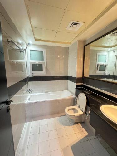 a bathroom with a tub and a toilet and a sink at RksHome Couple or Solo Room Burjuman Metro Exit 4 in Dubai