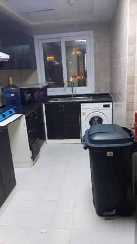 a kitchen with a trash can in the middle of it at RksHome Couple or Solo Room Burjuman Metro Exit 4 in Dubai