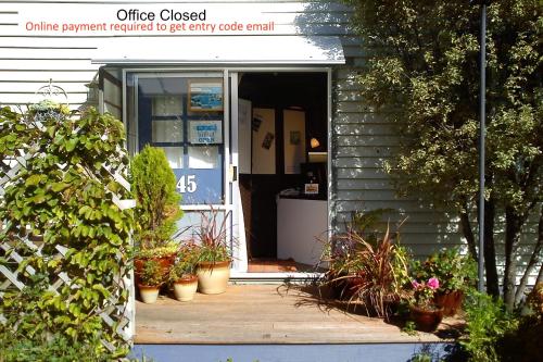 an open door of a house with potted plants at The Tuai Suite Waikaremoana in Tuai