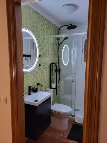 a bathroom with a toilet and a sink and a shower at King`s Apartments in San Javier