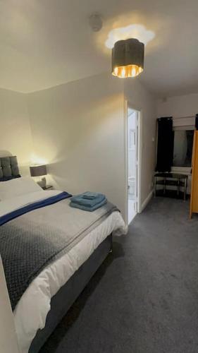 a bedroom with a bed and a light on the ceiling at 1 Luxe Exec Bedroom Apt Derby in Derby