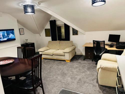 a living room with a couch and a table at 1 Luxe Exec Bedroom Apt Derby in Derby