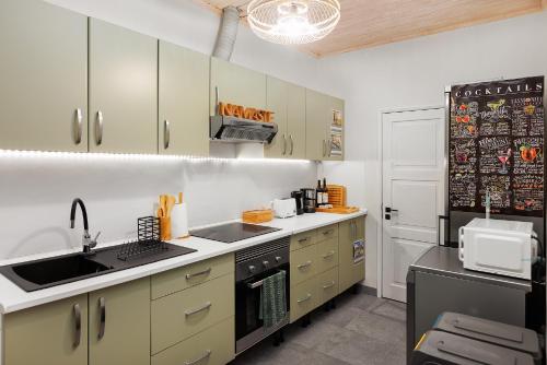 a kitchen with a sink and a stove at Quintinha Tropical - Panoramic Gateway to Madeira in Funchal
