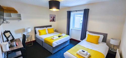 a small room with two beds and a window at mySTAYINN Telford Guest House in Inverness