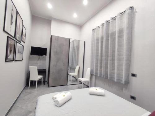 a bedroom with a bed and chairs and a mirror at Vista sull'Eremo in Naples