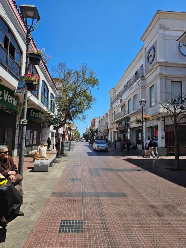 an empty street in a city with buildings at Casa en casco Historico Portal Del Valle in La Serena