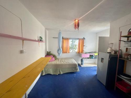 a bedroom with a bed and a blue floor at NooK in Sisal