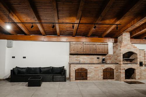 a living room with a couch and a brick fireplace at Casa Mecva in Borşa