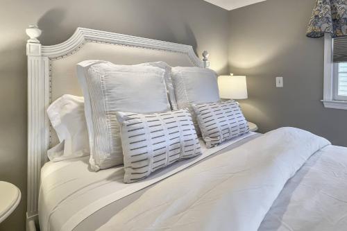 a white bed with white pillows on top of it at Candlewood Lake House in Danbury