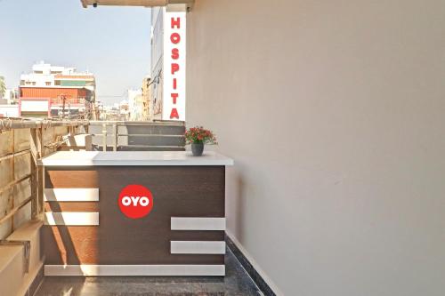a small counter on a balcony with a sign on it at Super OYO Flagship Sai Mansion in Hyderabad