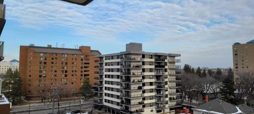a tall apartment building in the middle of a city at Smart Stylish Downtown Condo- 2 bedrooms in Saskatoon
