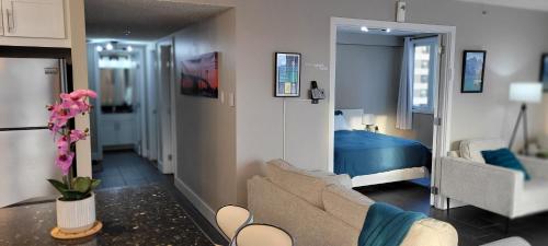 a living room with a couch and a bedroom at Smart Stylish Downtown Condo- 2 bedrooms in Saskatoon