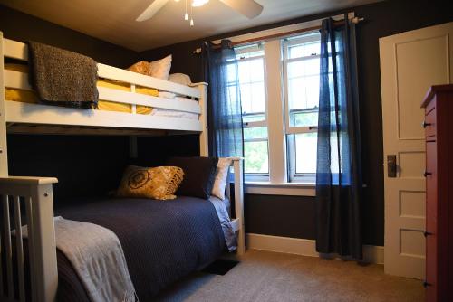 a bedroom with a bunk bed and a window at Cozy Home in Milwaukee Near Festivals and Brewers in Milwaukee