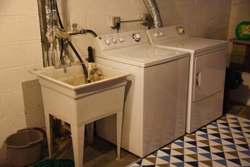 a bathroom with a sink and a washing machine at Cozy Home in Milwaukee Near Festivals and Brewers in Milwaukee