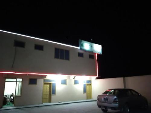 a car parked in front of a building at night at Bab e Gilgit Inn in Gilgit