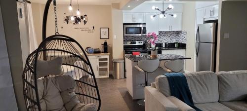 a living room with a couch and a kitchen at Smart Stylish Downtown Condo- 2 bedrooms in Saskatoon