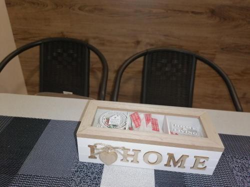 a box sitting on a table with two chairs at Bjelašnica Haven Lodge in Bjelašnica