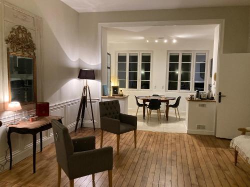 a living room with a table and chairs and a bedroom at Golf & Rempart in Angoulême
