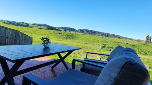 a table and a couch sitting on a patio at A stunning retreat in Rotorua! in Rotorua