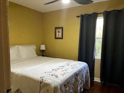 a bedroom with a bed with a ceiling fan and a window at Park View West in Lakeland