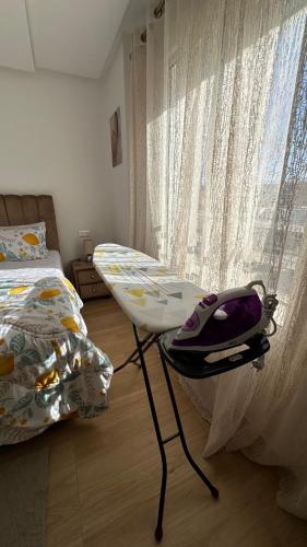 a bedroom with a bed and a chair next to a window at Luxury Family Appart 7 Pers - CheckPoint - Oujda Center in Oujda