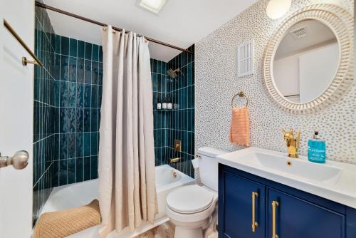 a bathroom with a toilet and a sink and a mirror at Beach Please condo 2 bedroom 2 bath sleeps 6 in Gulf Shores