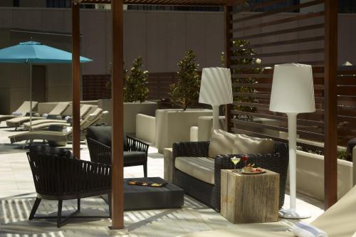 a patio with chairs and a table and lamps at Omni Charlotte Hotel in Charlotte