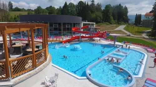 a large swimming pool with a water slide in it at Chalupa Šanov u Králík in Červená Voda