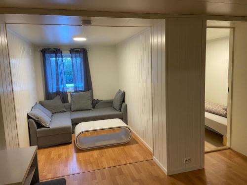 a small living room with a couch and a bed at Lovely one bedroom apartment in Tromsø