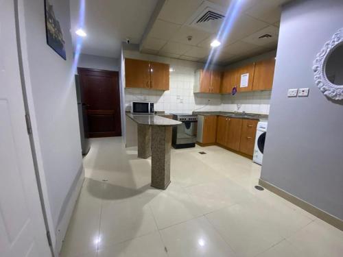a kitchen with a island in the middle of a room at Short Stay Partition Room in Al Barsha 1 Near Mashreq Metro in Dubai
