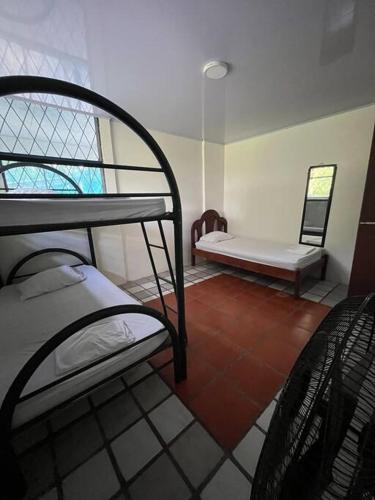 a room with two bunk beds and a bench at La Quinta de Ita in Morales