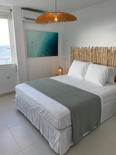 a bedroom with a large bed and a window at Face à la mer in Le Gosier