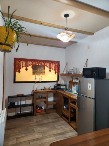 a kitchen with a stainless steel refrigerator and a table at Sanli in Mestia