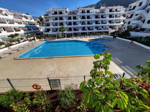 a large swimming pool in front of a large apartment building at Victoria Court II in Los Cristianos