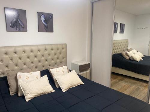 a bedroom with a large bed with a mirror at Carlos Paz-Lake Towers in Villa Carlos Paz