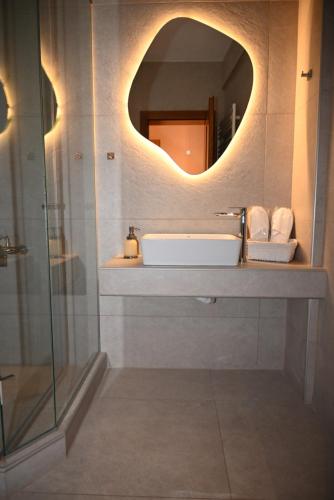 a bathroom with a sink and a mirror at Primula in Metsovo