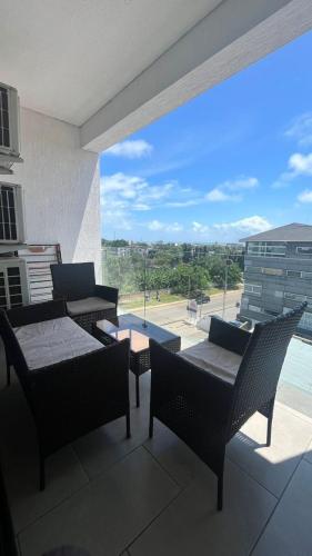 a balcony with furniture and a view of a building at Luxury Labone Edge 2-bedroom apartment in Accra - FiveHills homes in Accra